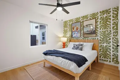 a bedroom with a bed and a ceiling fan at Stylish 2BR SD Retreat Firepit plus Outdoor Lounge in San Diego