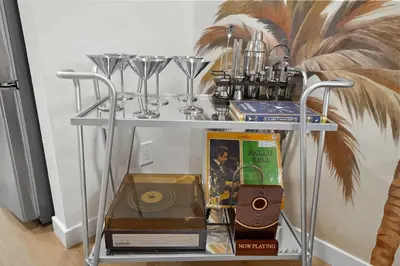 a shelf with a cd and other items on it at Stylish 2BR SD Retreat Firepit plus Outdoor Lounge in San Diego