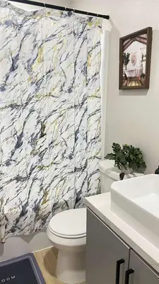 a bathroom with a white toilet and a marble shower curtain at Gillespie 1059 B 3Bed 2bath by SD Stay in Spring Valley