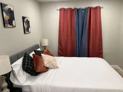 a bedroom with a bed with white sheets and pillows at Gillespie 1059 B 3Bed 2bath by SD Stay in Spring Valley
