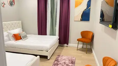 a small bedroom with a bed and a chair at Gillespie 1059 B 3Bed 2bath by SD Stay in Spring Valley