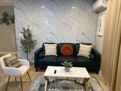 a living room with a black couch and a table at Gillespie 1059 B 3Bed 2bath by SD Stay in Spring Valley