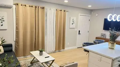 a living room with brown curtains and a table at Gillespie 1059 B 3Bed 2bath by SD Stay in Spring Valley