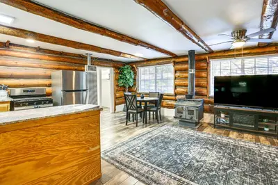a living room with a television and a stove at MTB Base Camp! Rustic Cabin By Mt Laguna Trails in Mount Laguna