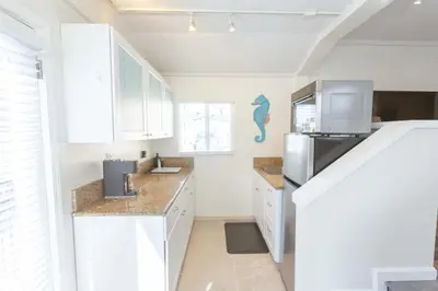 a kitchen with white cabinets and a refrigerator at Beach to Bay The Ultimate SD location in San Diego