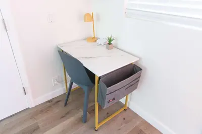 a desk with a plant on top of it in a room at Beach to Bay The Ultimate SD location in San Diego