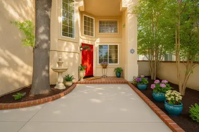 a house with a driveway with a red door at Peaceful Poolside Perfection near Wine Country in Murrieta