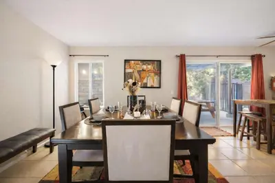 a dining room with a table and chairs and a dining room at Peaceful Poolside Perfection near Wine Country in Murrieta