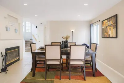 a dining room with a table and chairs and a fireplace at Peaceful Poolside Perfection near Wine Country in Murrieta