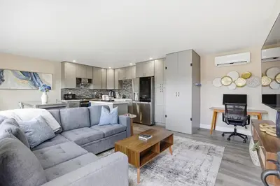 a living room with a couch and a table at New Modern 2BR Home with Movie theater, & Big Yard in La Mesa