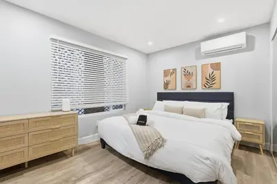 a bedroom with a large bed and a window at New Modern 2BR Home with Movie theater, & Big Yard in La Mesa