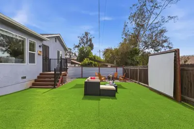 a backyard with a lawn with green grass at New Modern 2BR Home with Movie theater, & Big Yard in La Mesa