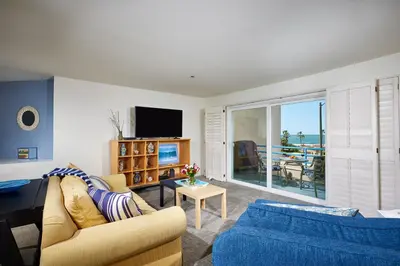 a living room with a couch and a tv at 4P-201 Ocean View Steps to Beach in Oceanside