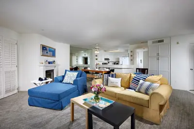 a living room with a couch and a blue chair at 4P-201 Ocean View Steps to Beach in Oceanside