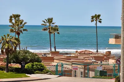 a beach with palm trees and the ocean at 4P-201 Ocean View Steps to Beach in Oceanside