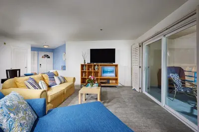 a living room with a couch and a tv at 4P-201 Ocean View Steps to Beach in Oceanside