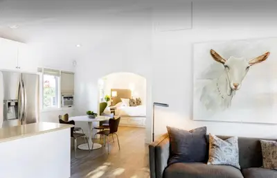 a kitchen and living room with a couch and a painting of a goat at 2 Bedroom Lux Casita with Resort Amenities in Encinitas