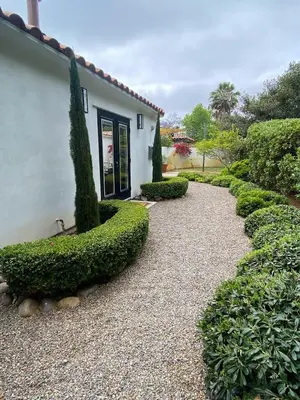 a garden with bushes and a building and a walkway at 2 Bedroom Lux Casita with Resort Amenities in Encinitas