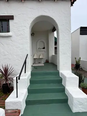 a stairway leading up to a house with green stairs at Casa Cabrillo in San Clemente