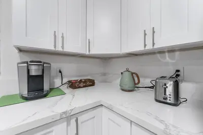 a kitchen with white cabinets and a counter top with a toaster at Luxury Retreat, Foosball, Pool table, NEW Upgrades in Chula Vista