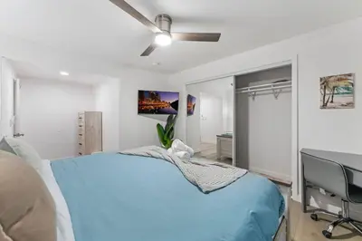 a bedroom with a blue bed and a desk at Luxury Retreat, Foosball, Pool table, NEW Upgrades in Chula Vista