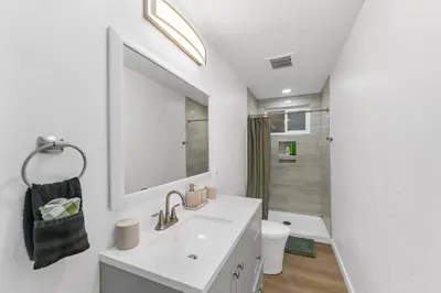 a white bathroom with a sink and a toilet at Luxury Retreat, Foosball, Pool table, NEW Upgrades in Chula Vista