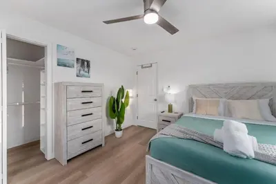 a bedroom with a bed and a ceiling fan at Luxury Retreat, Foosball, Pool table, NEW Upgrades in Chula Vista