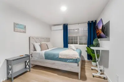 a bedroom with a bed and a window at Luxury Retreat, Foosball, Pool table, NEW Upgrades in Chula Vista