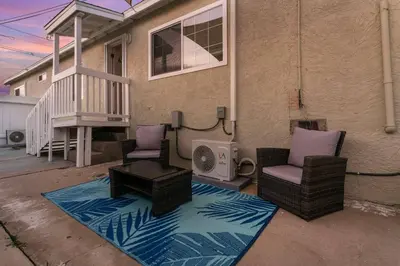 a patio with two chairs and a table and a house at Luxury Retreat, Foosball, Pool table, NEW Upgrades in Chula Vista