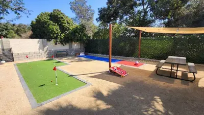 a backyard with a picnic table and a playground at Spacious 4BR w/ Pool, Spa, Mini Golf & Game Lounge in Chula Vista