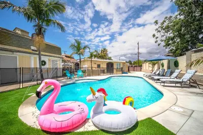 two inflatable flamingos in a swimming pool at Spacious 4BR w/ Pool, Spa, Mini Golf & Game Lounge in Chula Vista