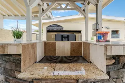 an outdoor kitchen with a grill in a house at Spacious 4BR w/ Pool, Spa, Mini Golf & Game Lounge in Chula Vista