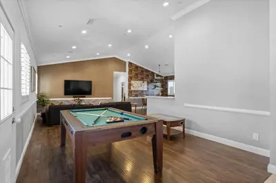 a living room with a ping pong table at Spacious 3BR Home with Pool in La Mesa