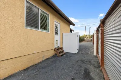 a building with a white refrigerator next to a garage at Spacious 3BR Home with Pool in La Mesa