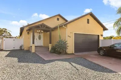 a house with a car parked in front of it at Spacious 3BR Home with Pool in La Mesa