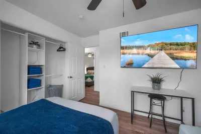 a bedroom with a bed and a tv on the wall at Family Retreat w/ Theater, Pool & Outdoor Dining in Chula Vista