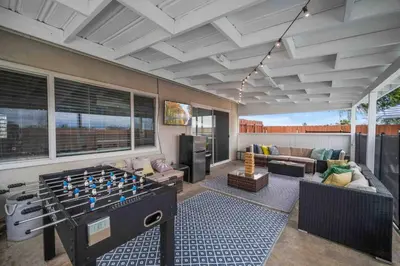 a living room with a foos ball in the middle of a living room at Family Retreat w/ Theater, Pool & Outdoor Dining in Chula Vista