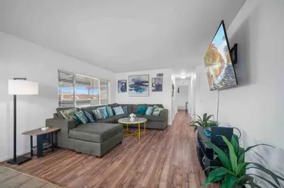 a living room with a couch and a table at Family Retreat w/ Theater, Pool & Outdoor Dining in Chula Vista