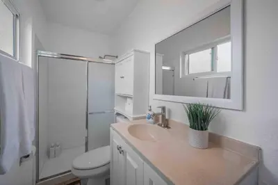 a bathroom with a sink and a toilet and a mirror at Family Retreat w/ Theater, Pool & Outdoor Dining in Chula Vista