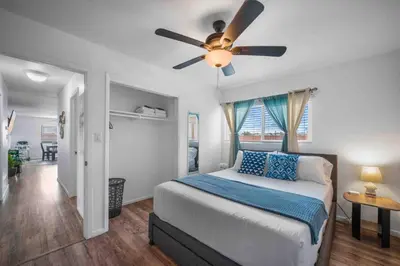 a bedroom with a bed and a ceiling fan at Family Retreat w/ Theater, Pool & Outdoor Dining in Chula Vista