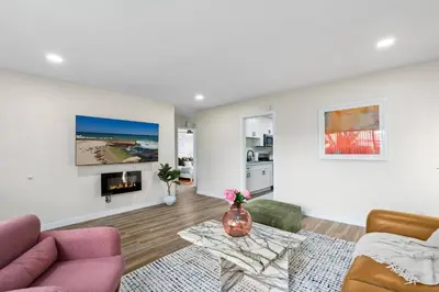 a living room with a couch and a fireplace at Pacific Beach Paradise-Walk to Beach &Bay in San Diego