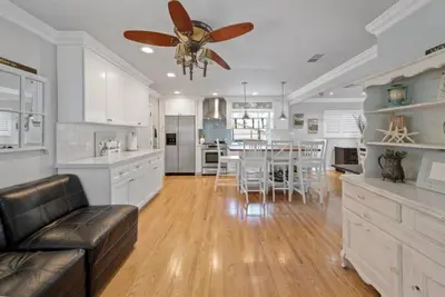 a kitchen and dining room with a ceiling fan at SDSU Beach Cottage in San Diego