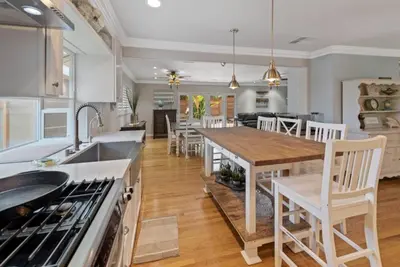 a kitchen with a table and chairs in a kitchen at SDSU Beach Cottage in San Diego