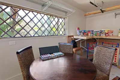 a dining room with a wooden table and chairs at SDSU Beach Cottage in San Diego