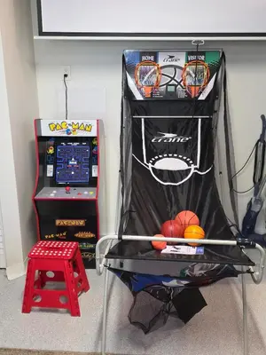 a basketball hoop and a table with a game at Sunny 5BEDR00MS with Pool, Zip Line, Game Room, Kid's Playhouse in San Diego