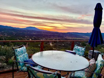 a table and chairs on a balcony with a view at Cahuilla Mountain Retreat in Anza