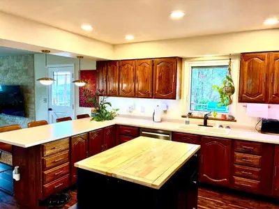 a kitchen with wooden cabinets and a counter top at Cahuilla Mountain Retreat in Anza