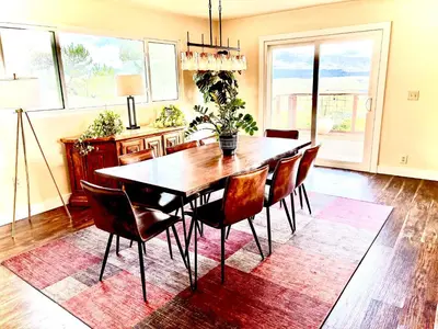 a dining room with a table and chairs on a rug at Cahuilla Mountain Retreat in Anza