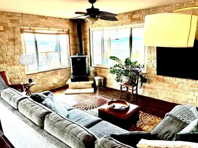 a living room with a couch and a flat screen tv at Cahuilla Mountain Retreat in Anza