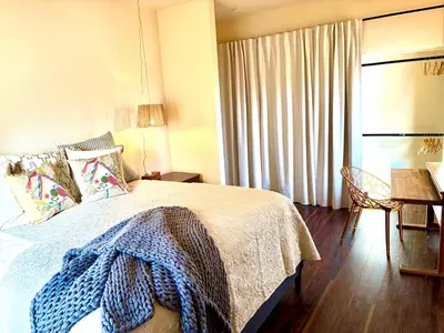 a bedroom with a bed with a blue blanket on it at Cahuilla Mountain Retreat in Anza